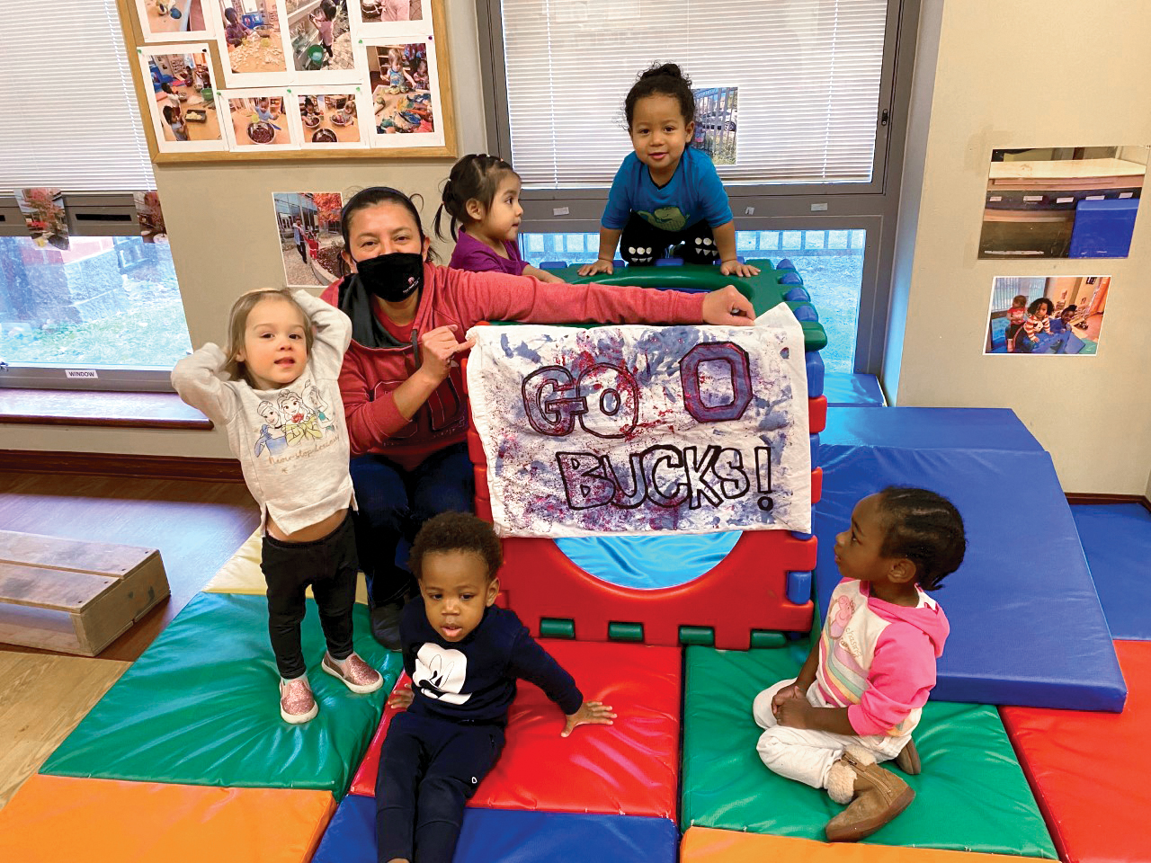 pre-school students with teacher in masks