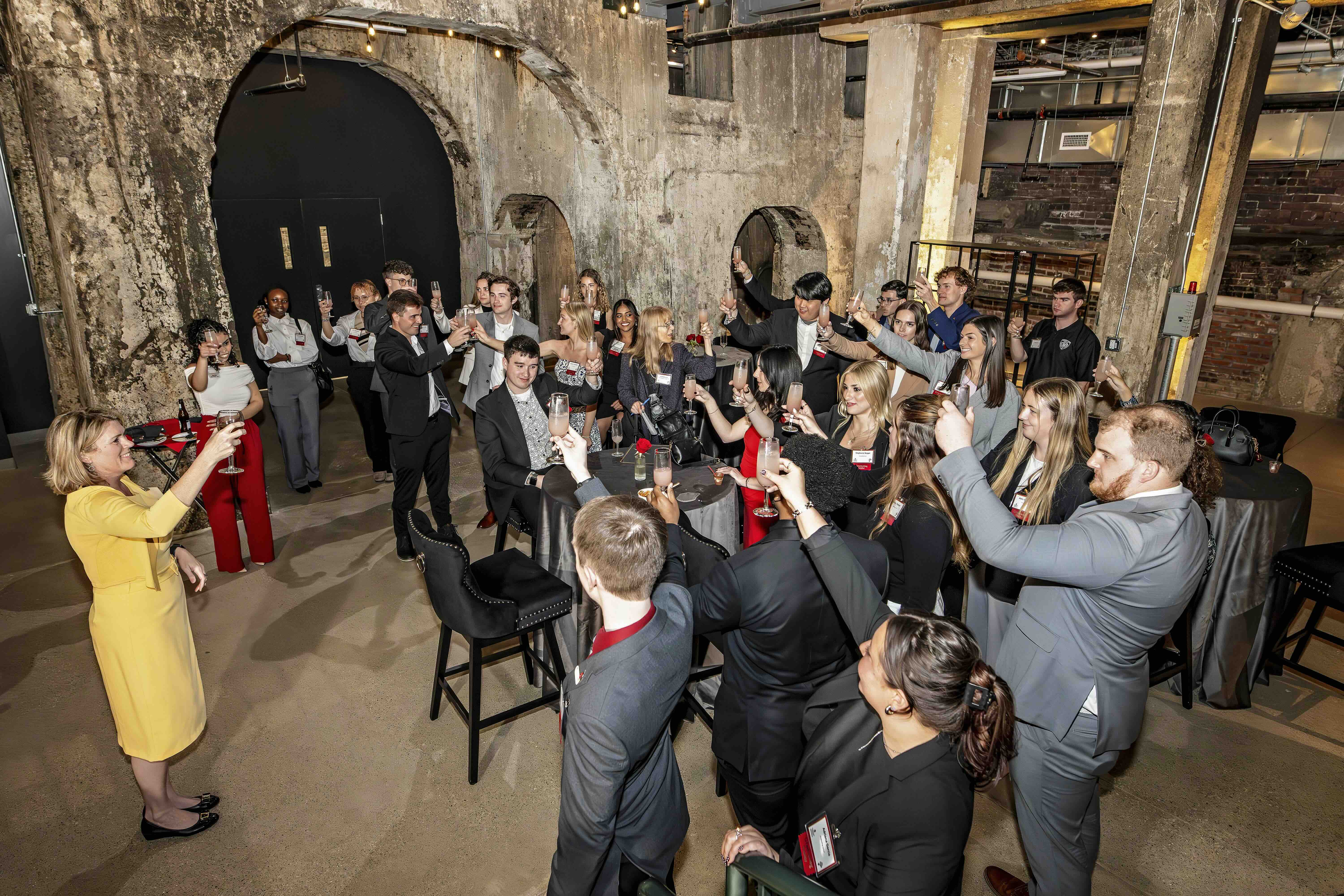 Anne Turpin toasting students at Big Dish event in a wine cellar