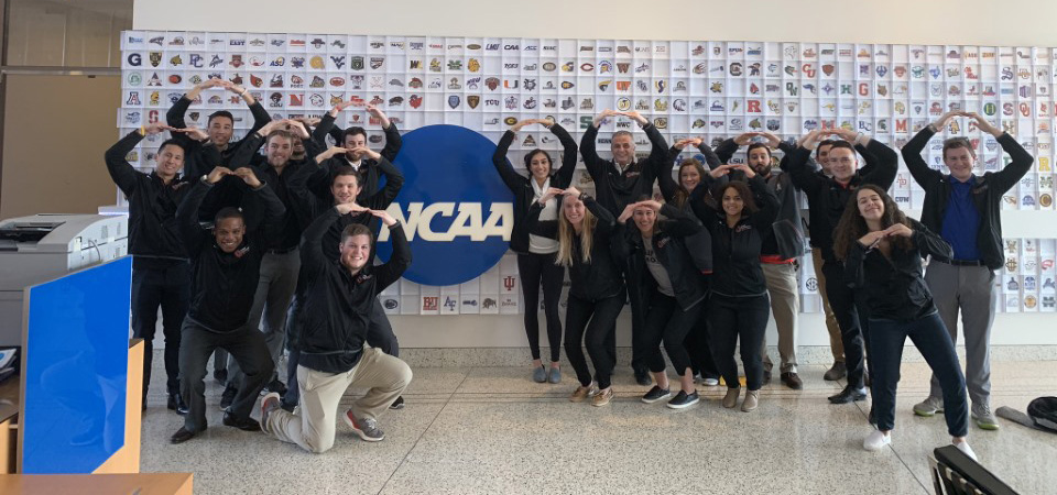 Ohio State students in front of NCAA sign