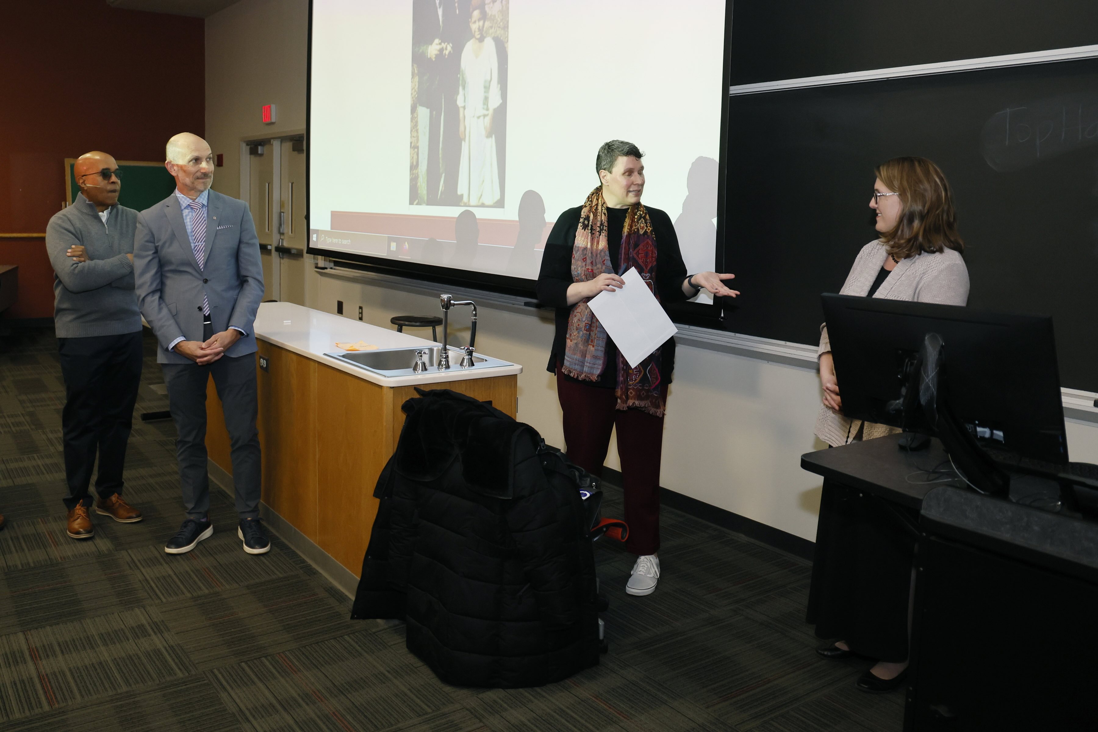 Angela Collene receiving an award in the classroom