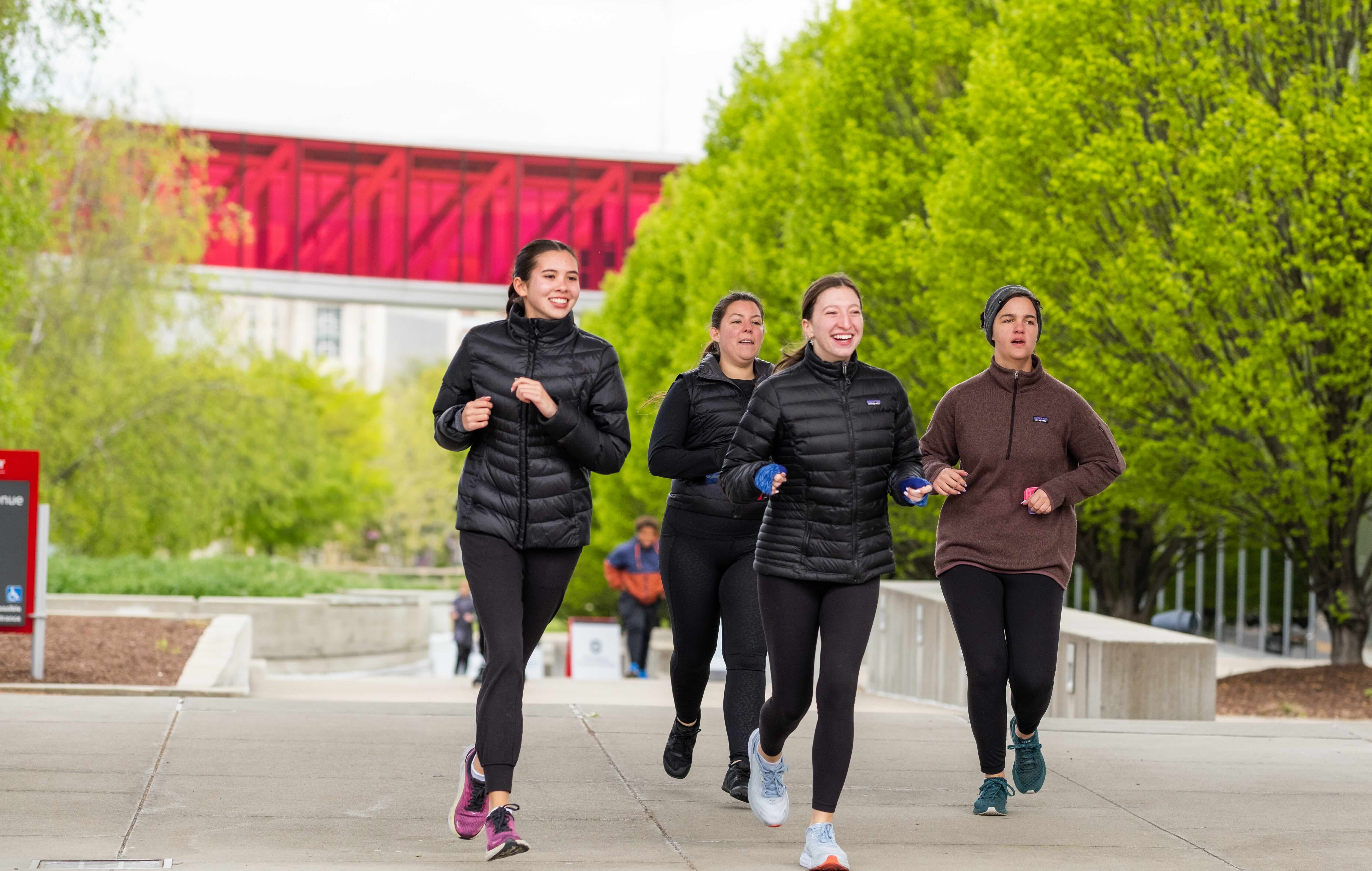 Group of Ohio State students jogging through campus