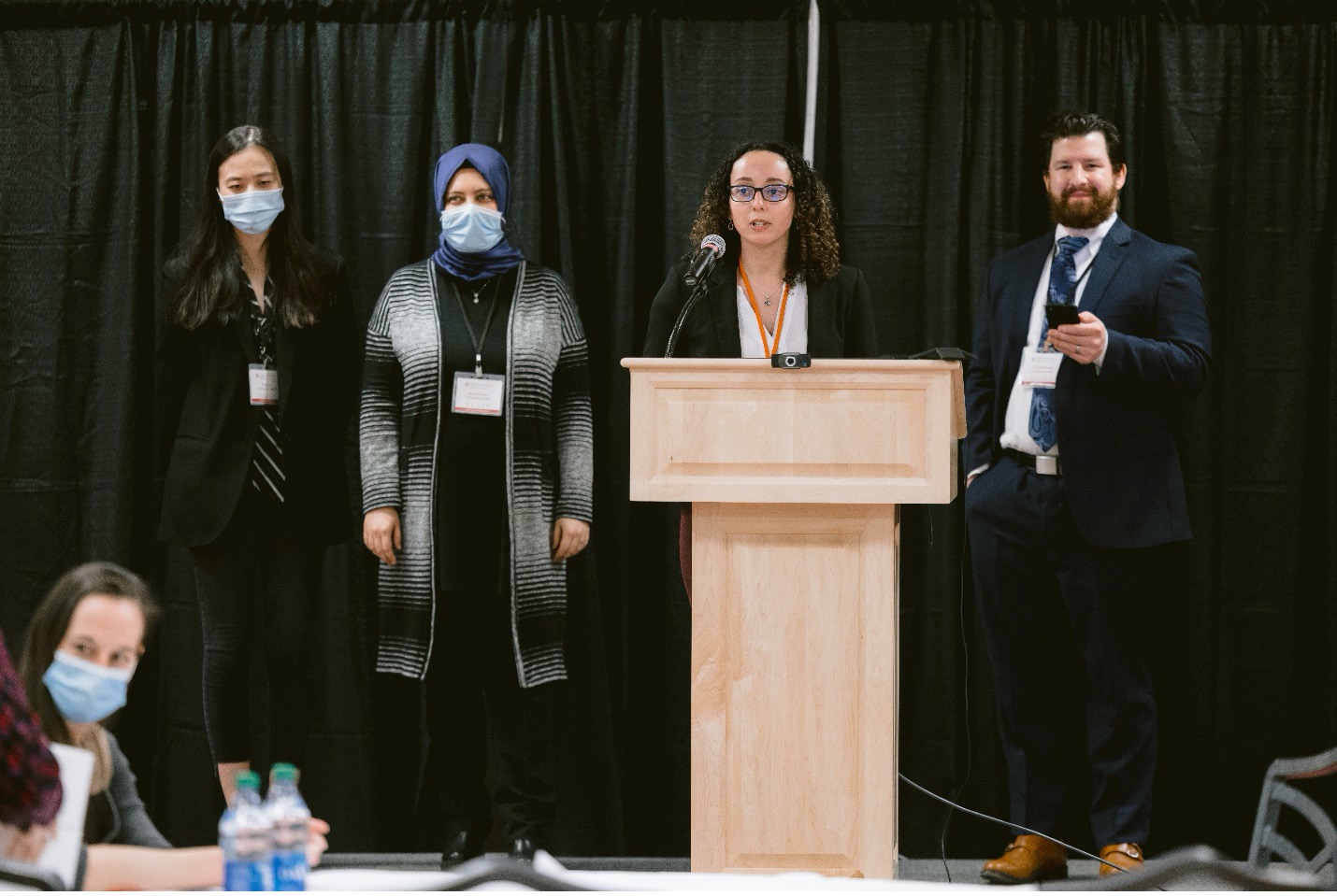 Research forum speakers at podium