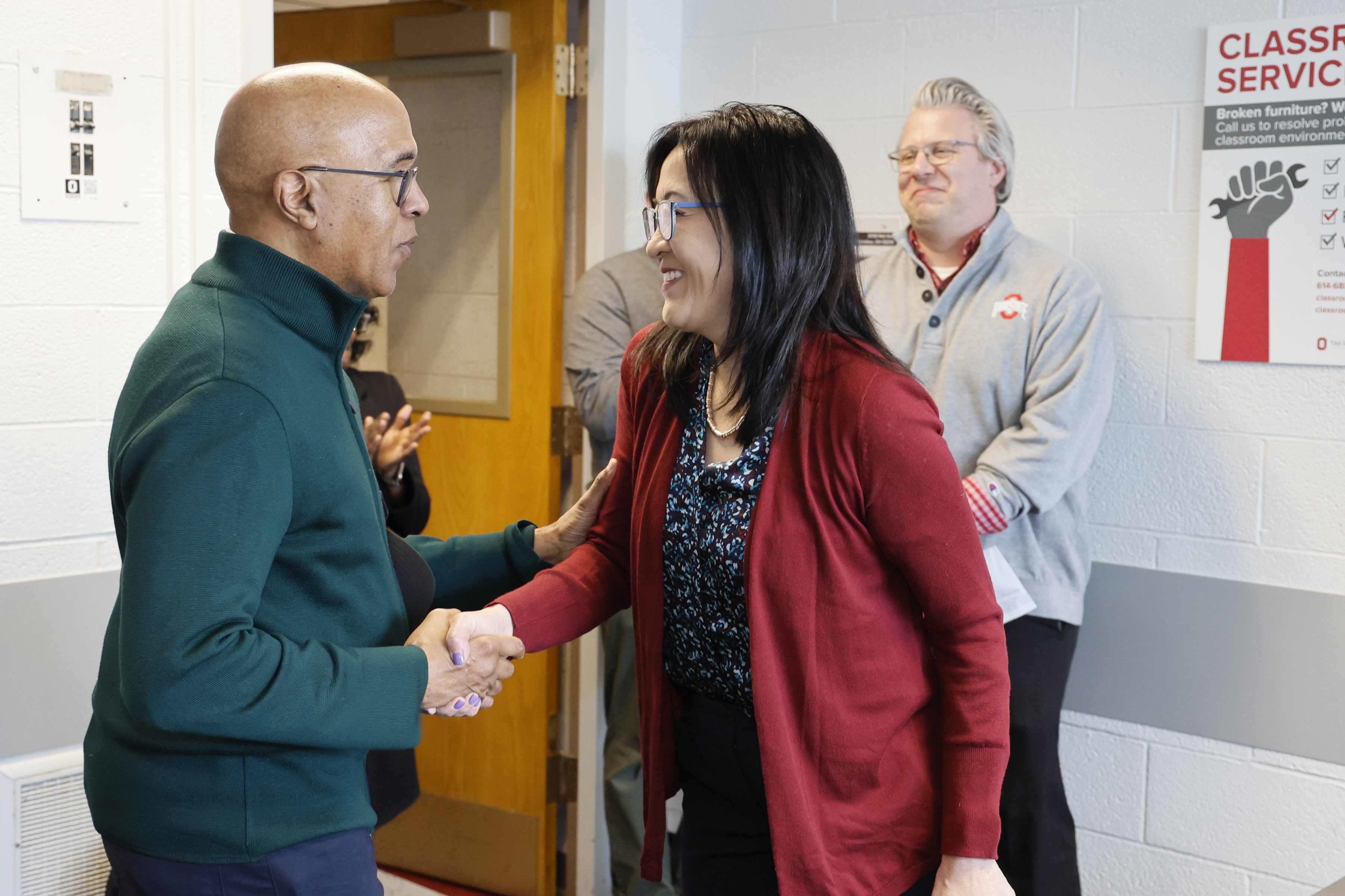 Shirley Yu and Dean Don Pope-Davis shaking hands
