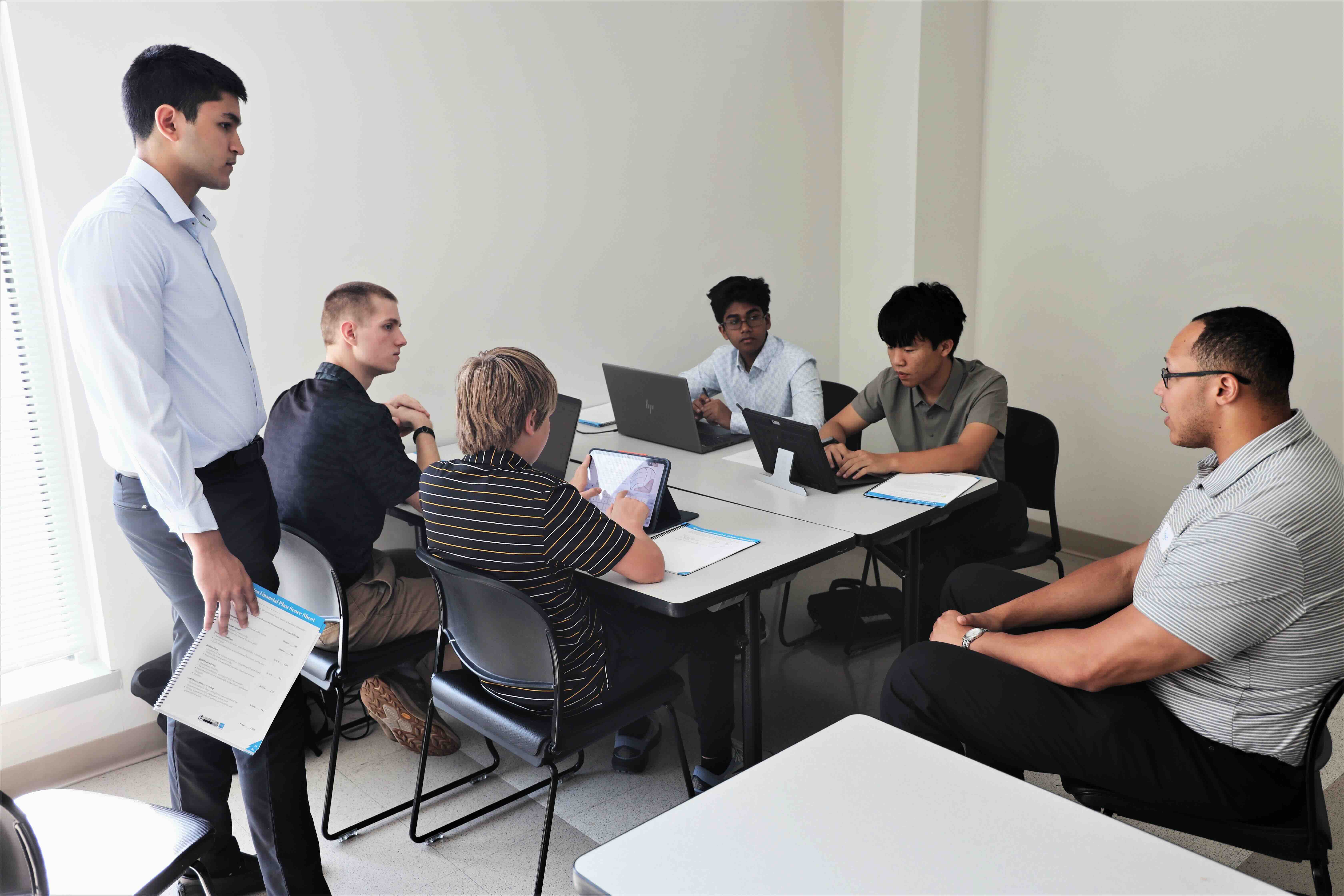 Students working in groups to create draft financial plans