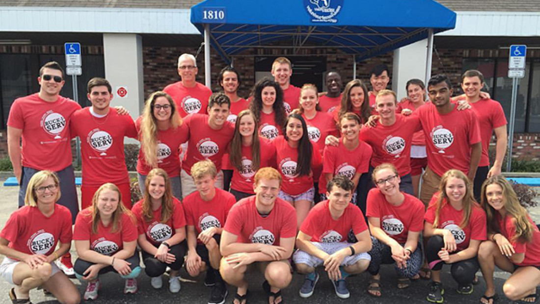 a group of people in red shirts posing for a picture