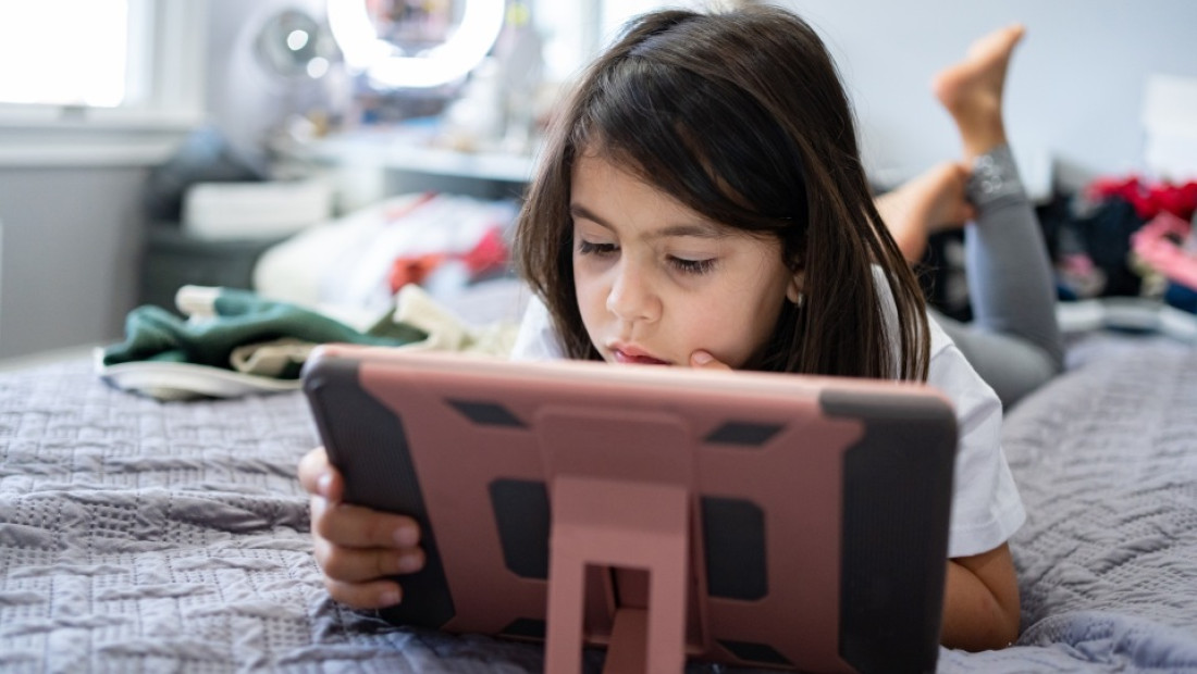 Young girl using iPad tablet
