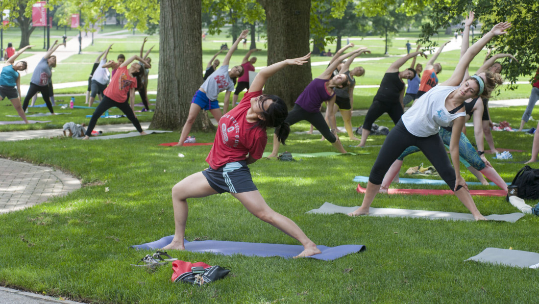 Ohio State students doing Yoga outside on campus