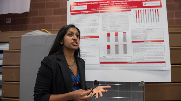 An EHE grad student with research poster