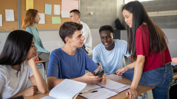 High school students conversing in a classroom