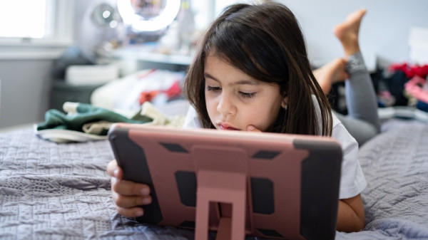 Young girl using iPad tablet
