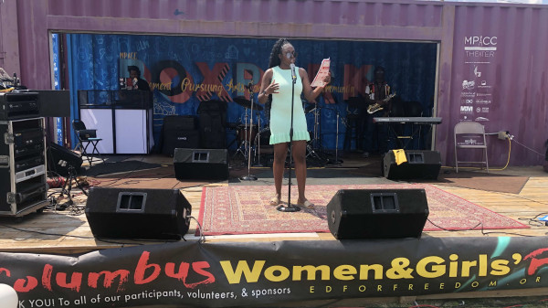 Woman speaking on stage at the Columbus Women & Girls Fest 2024