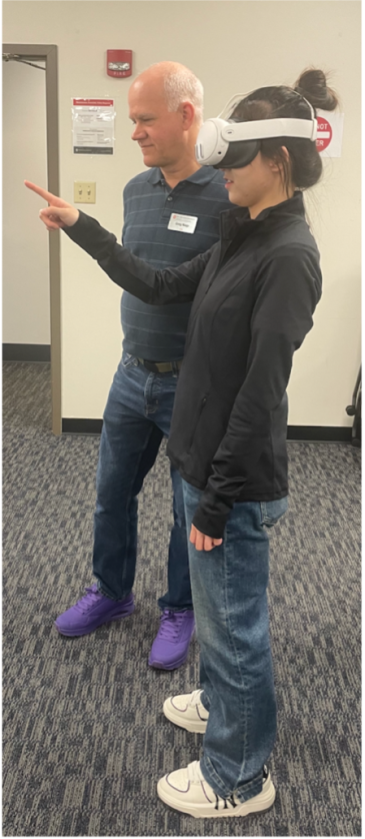 Ohio State professor teaching a student to use a VR headset