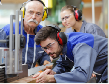 Workers wearing headphones while using machinery