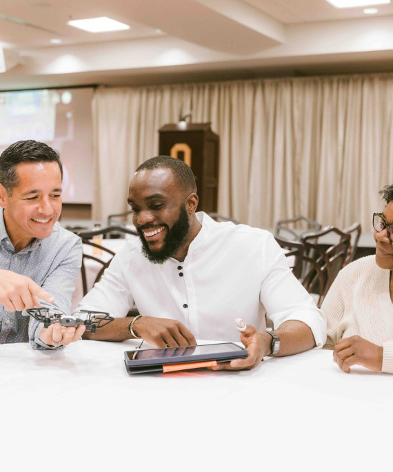 Conference attendees working on drones during the CDLI event
