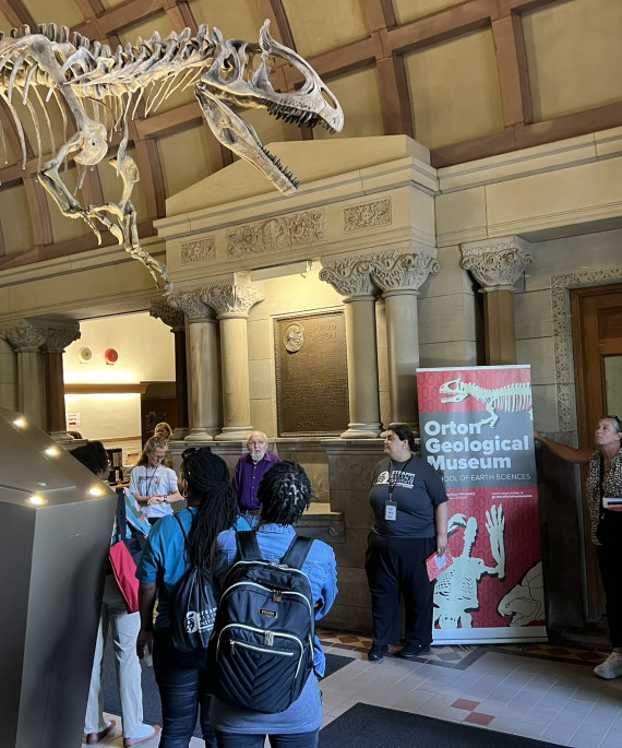 Ohio State STEAMM Rising program at a museum looking at dinosaur skeleton