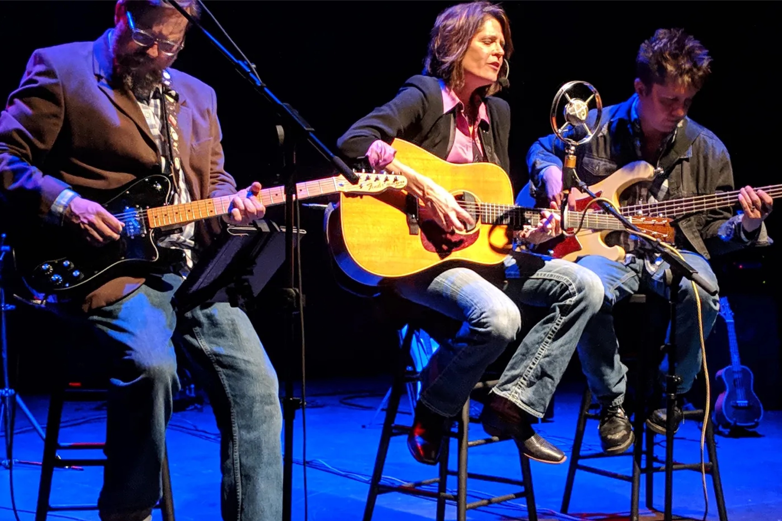 Musicians on stage play guitars