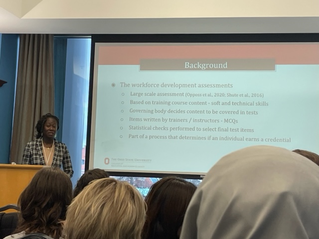 Abena Anyidoho speaking at a podium during a presentation