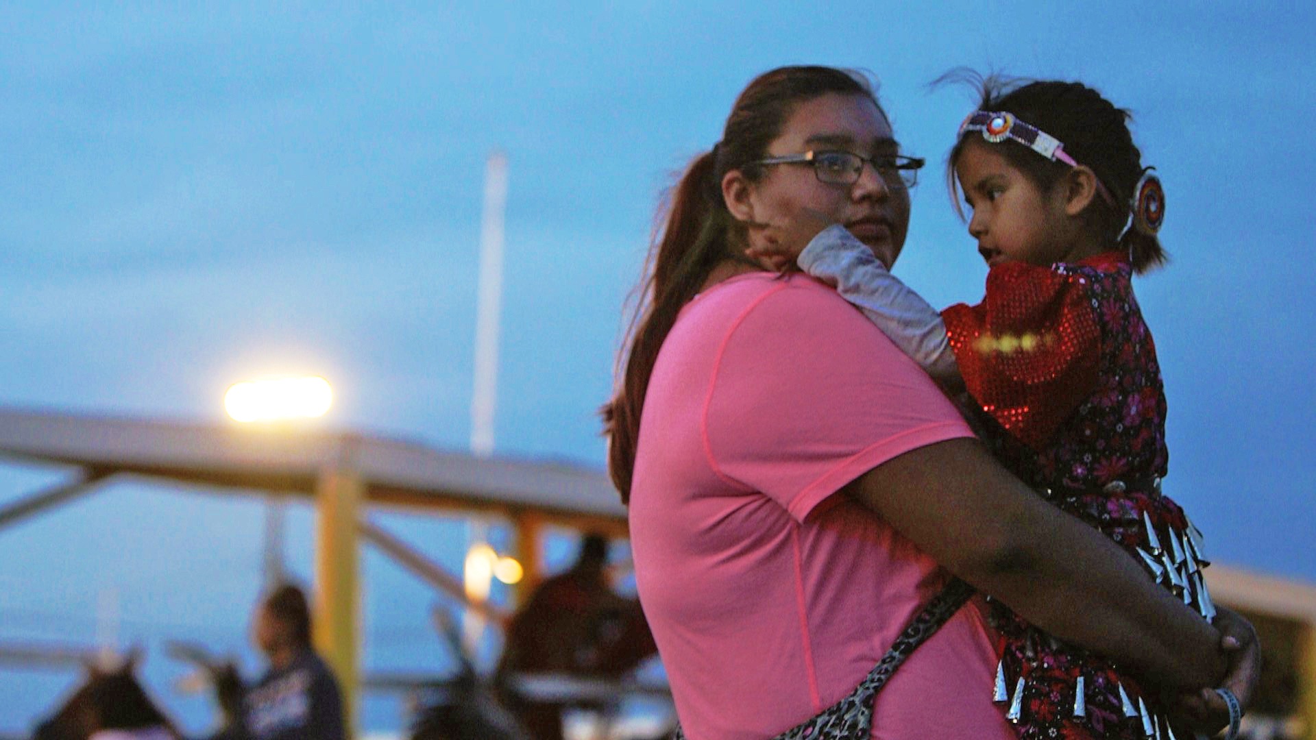 Native American woman holding young child
